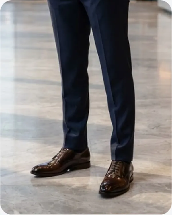 Brown brogues worn with navy trousers