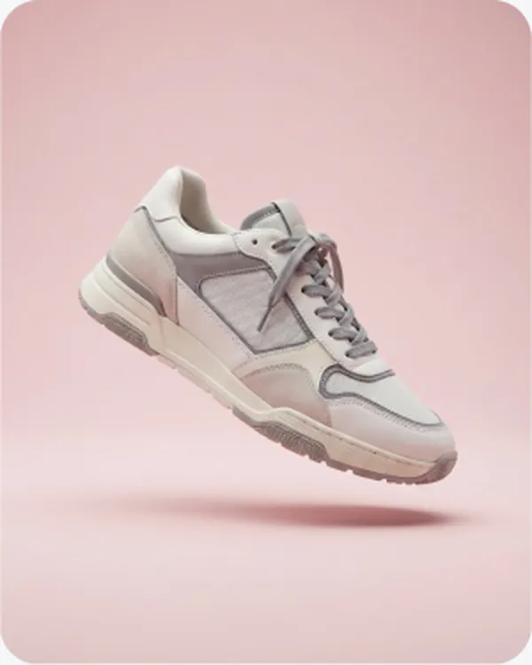 Grey running shoe on a pink ground
