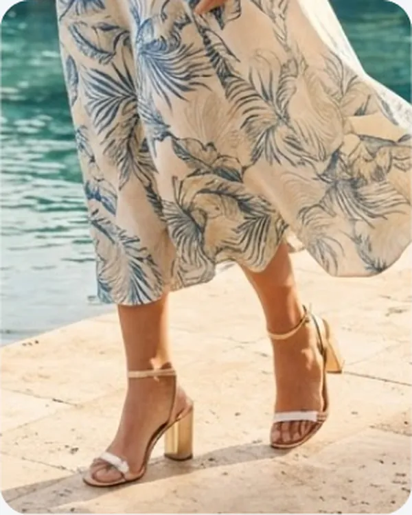 Tan heeled sandals worn on a terrace