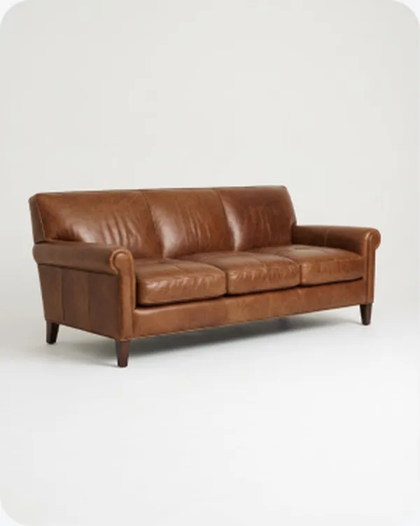 Tan leather sofa on a plain ground